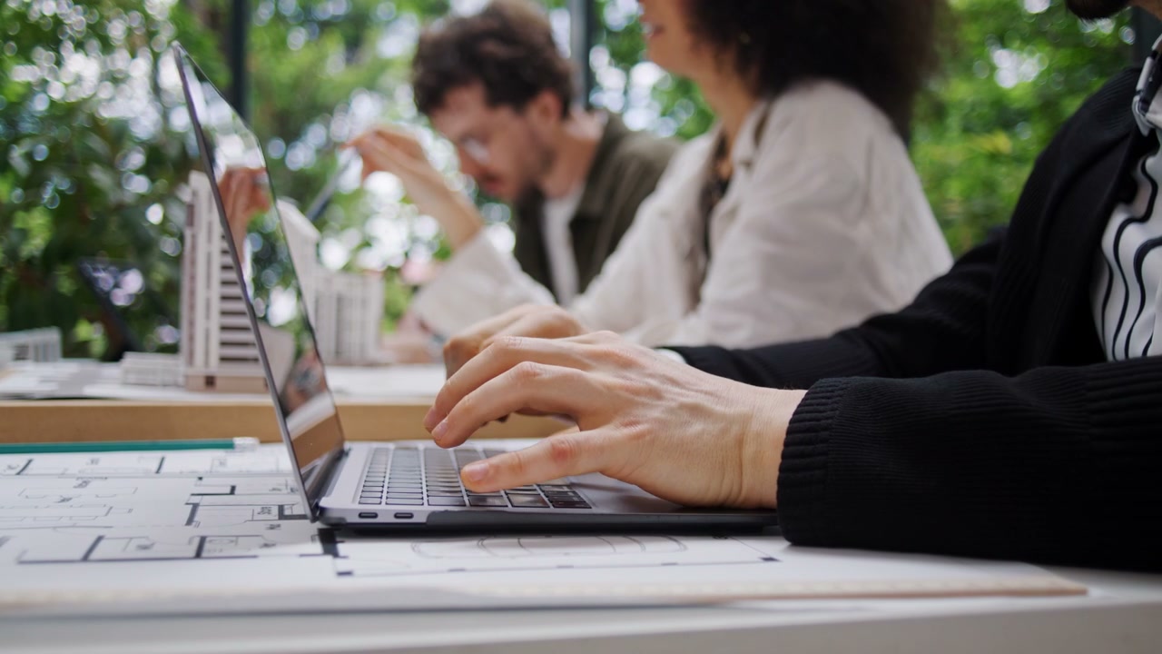 Architects Collaborating on Laptops