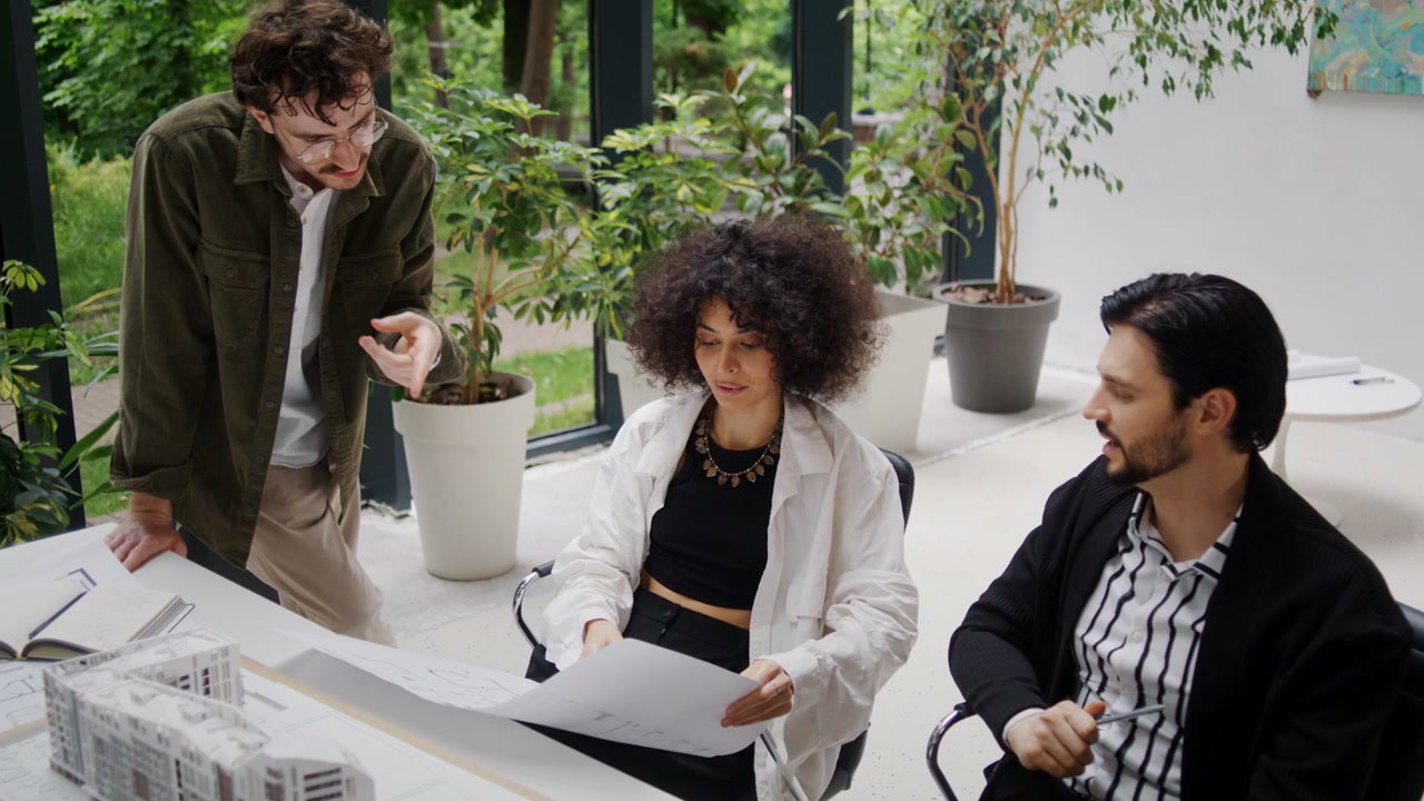 Architects Discussing Plans in Modern Office