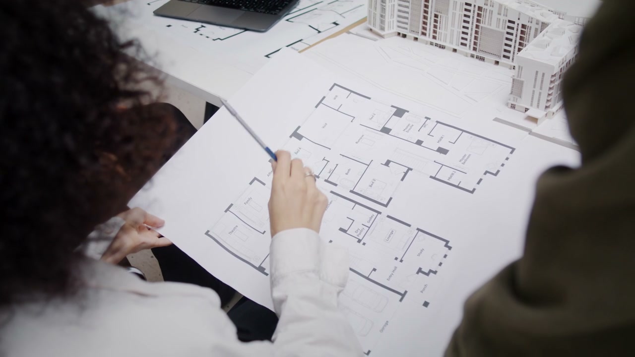 Two Architects Reviewing Building Blueprints