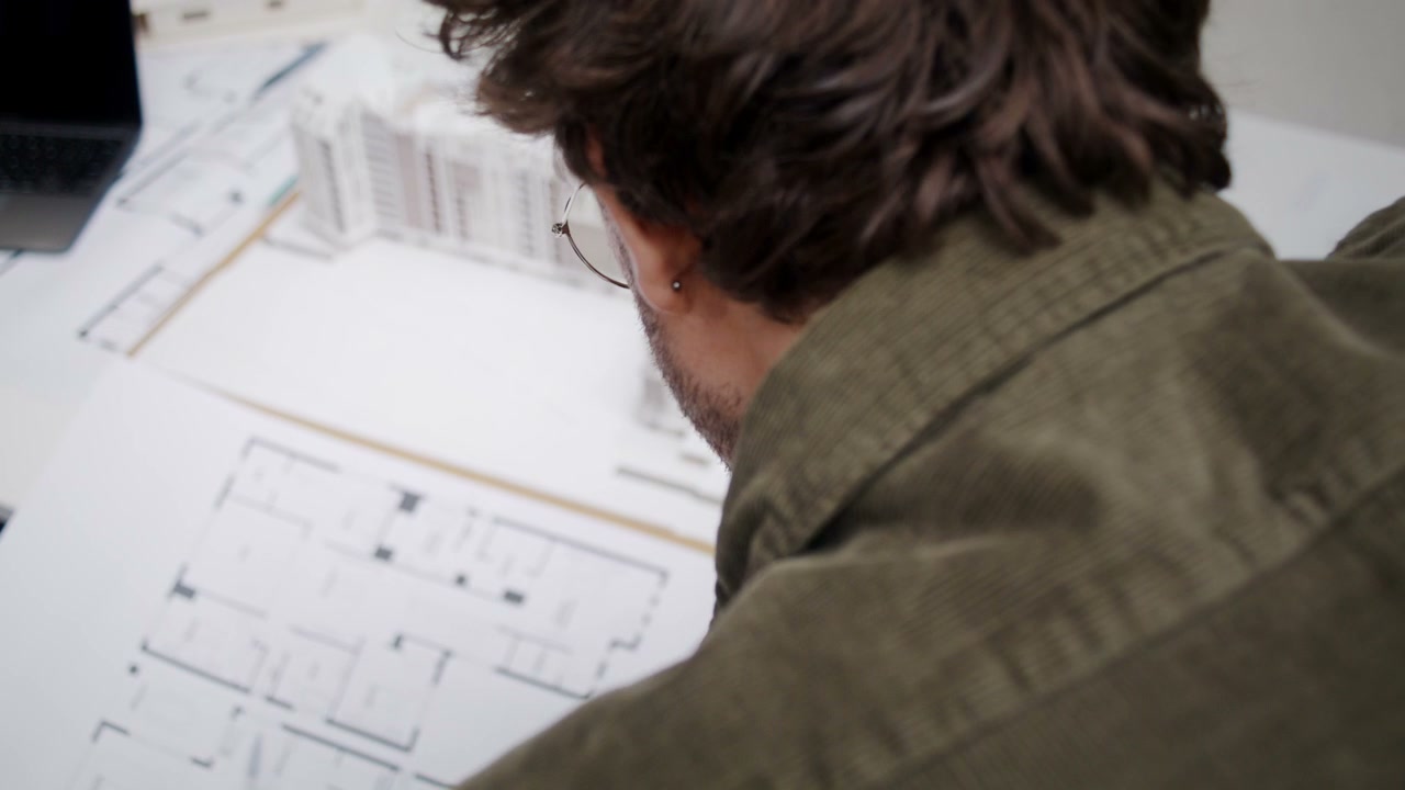 Man Reviewing Architectural Blueprints