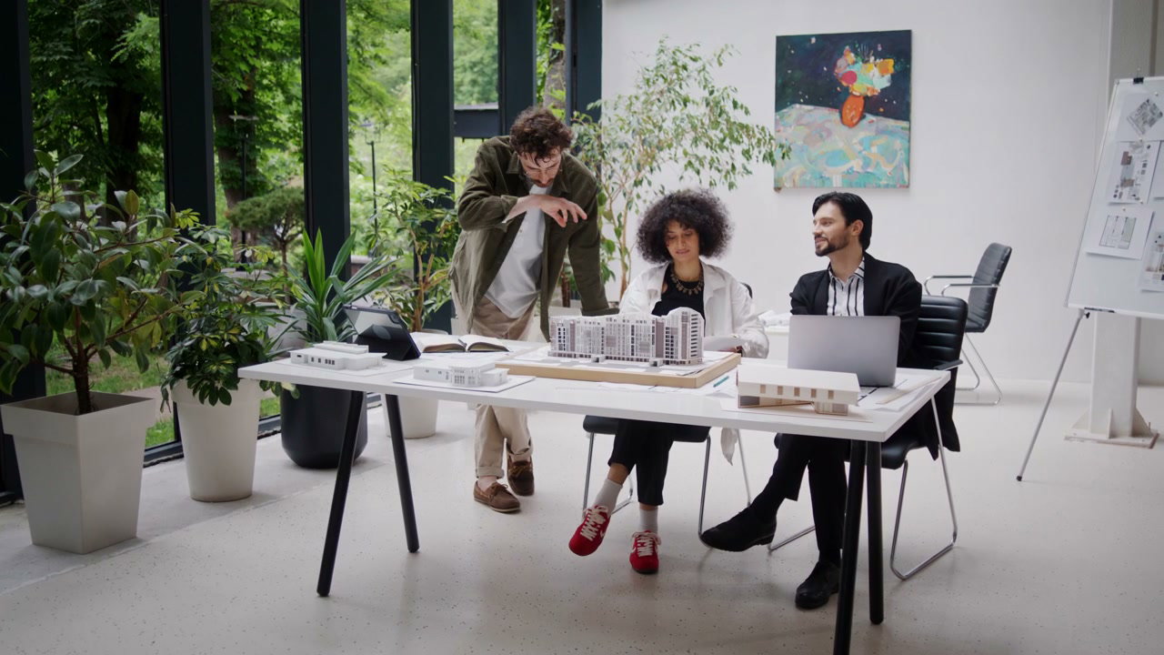 Architecture Team Discussing Building Model
