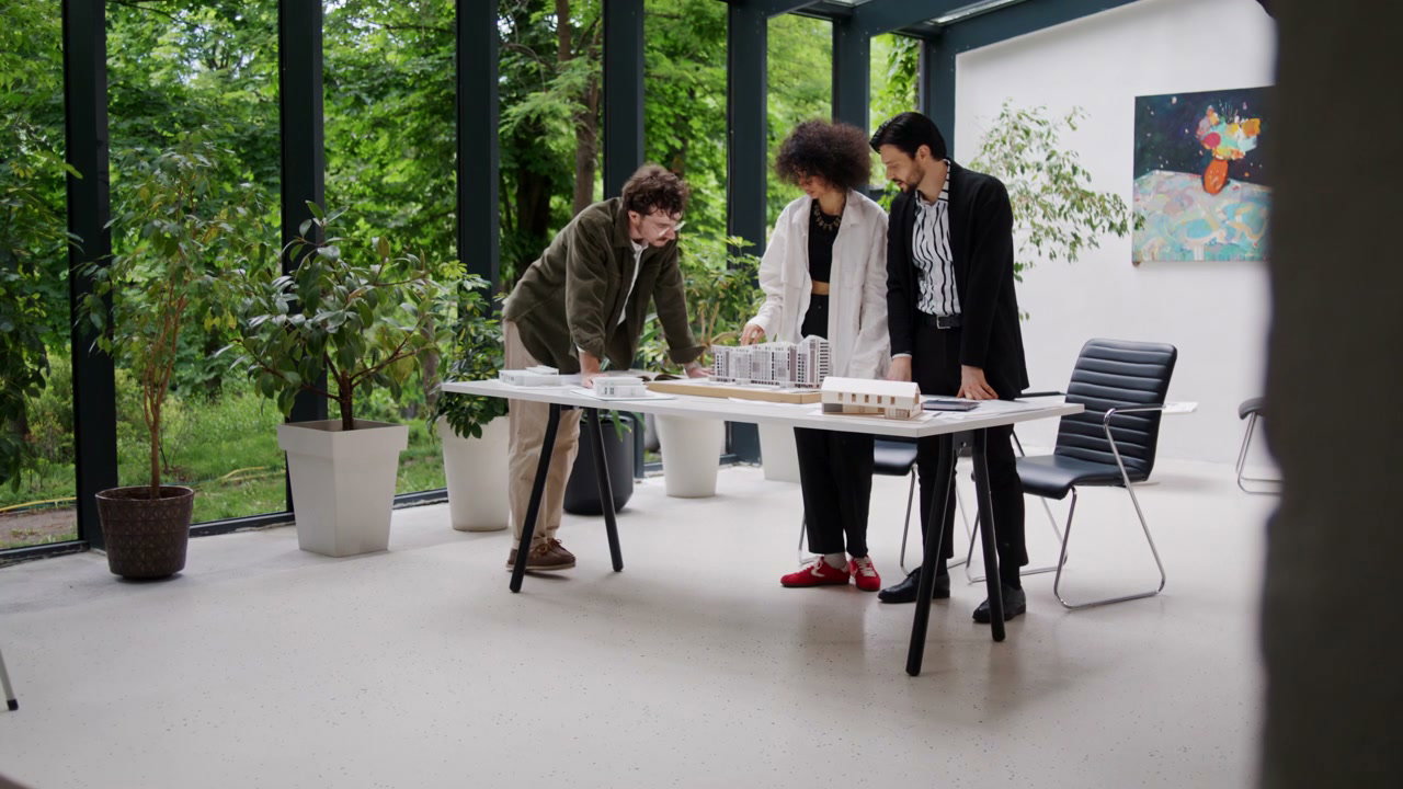 Team of Architects Discussing Building Model