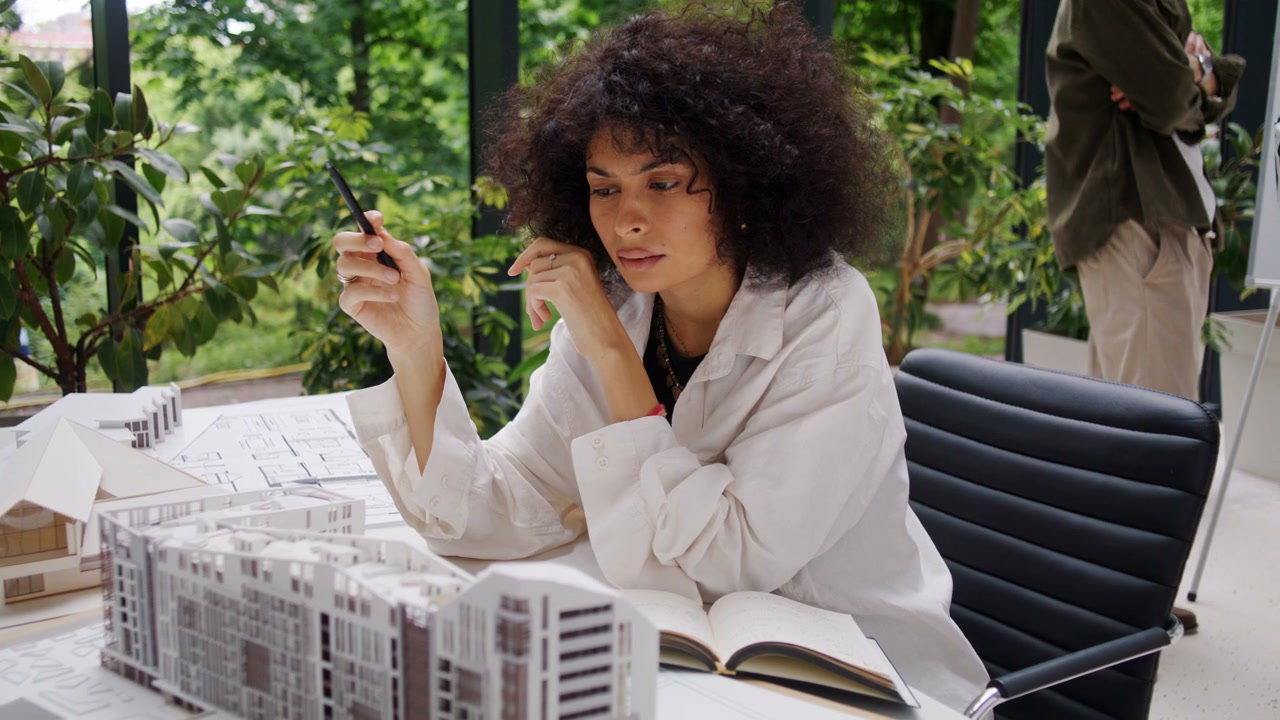 Woman Architect Reviewing Building Models
