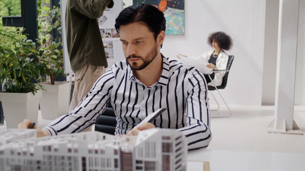 Architect Working on Building Model in Office