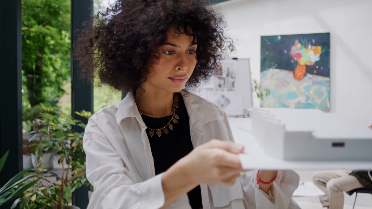Female Architect Examining Building Model
