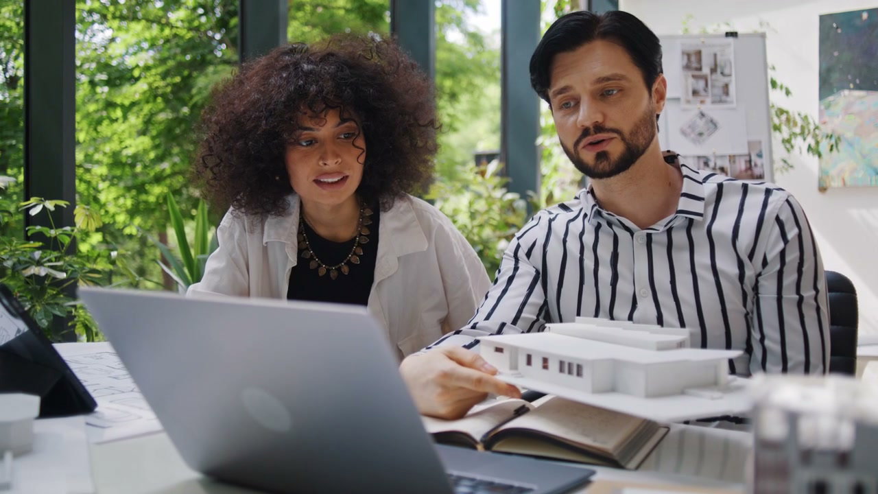 Architects Discussing Building Model in Office
