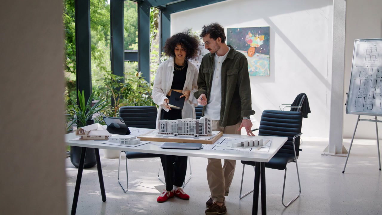 Architect Colleagues Discuss Building Model