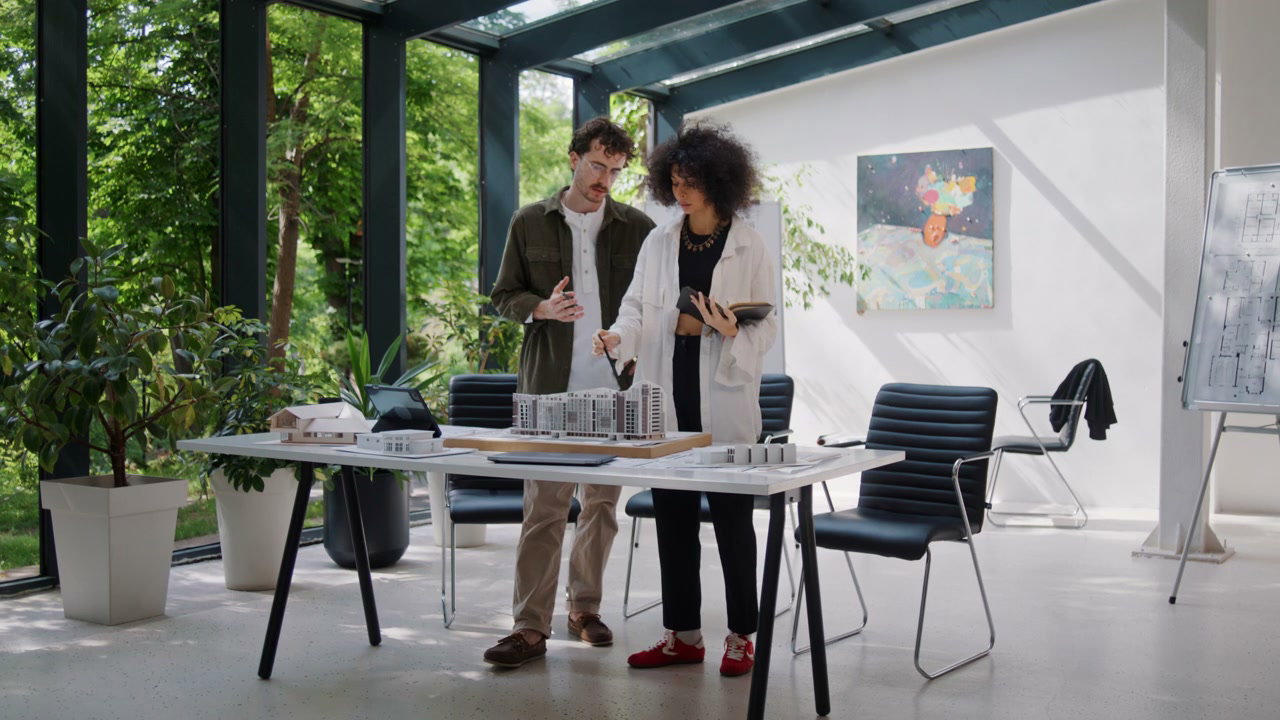 Architects Discussing Building Model in Office