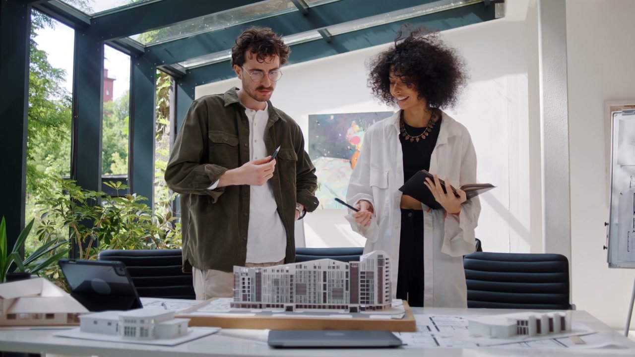 Architects Discussing Building Model in Office
