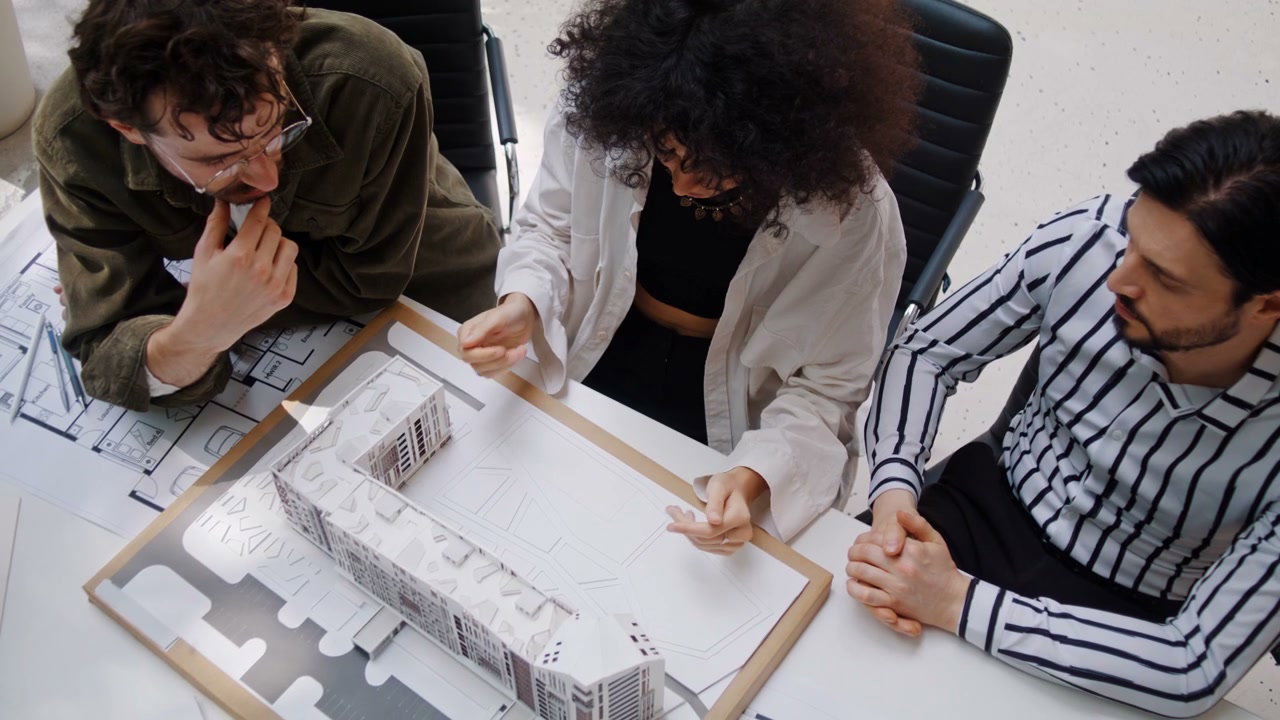 Architects Discussing Project Model in Office