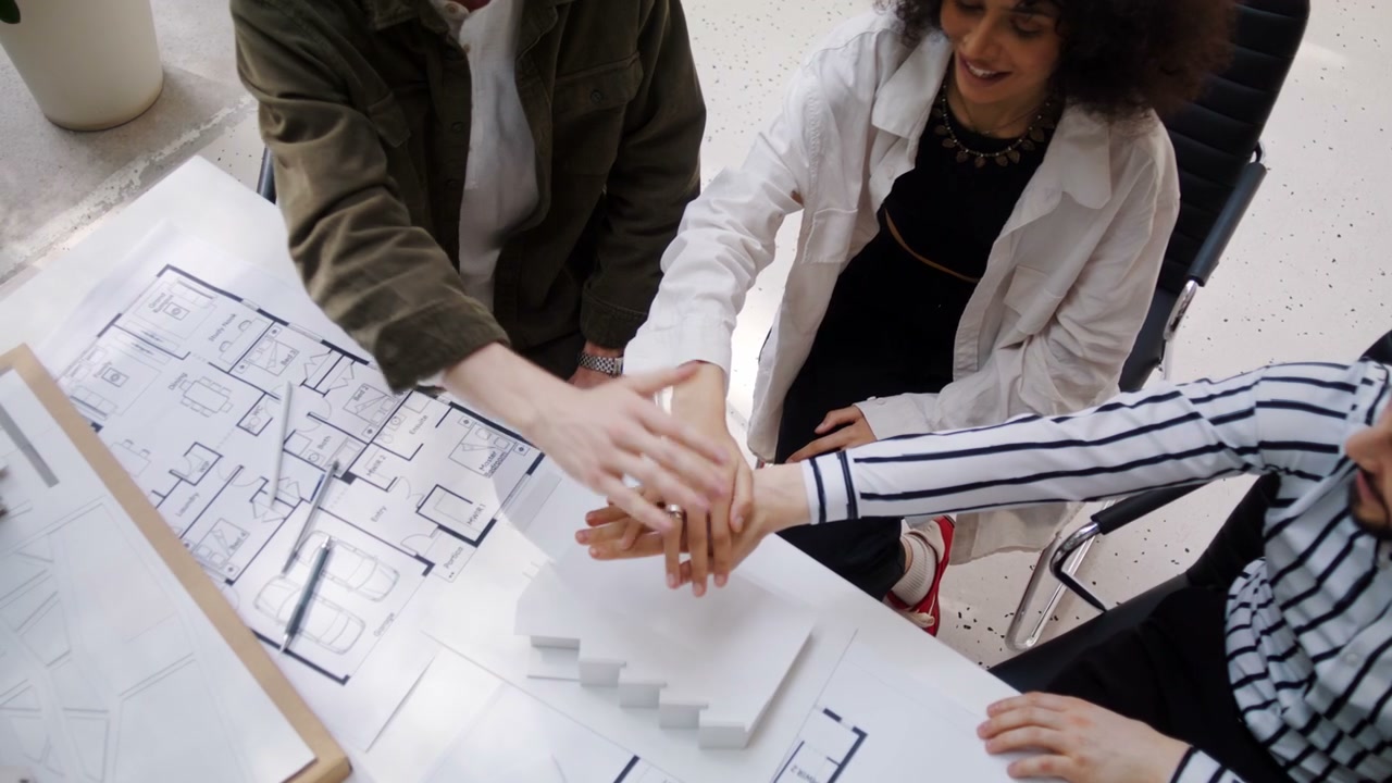 Architects Team Stacks Hands Over Plans