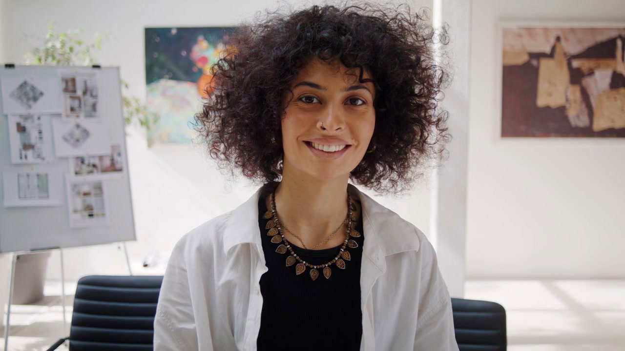 Smiling Woman Looking at Camera in Office