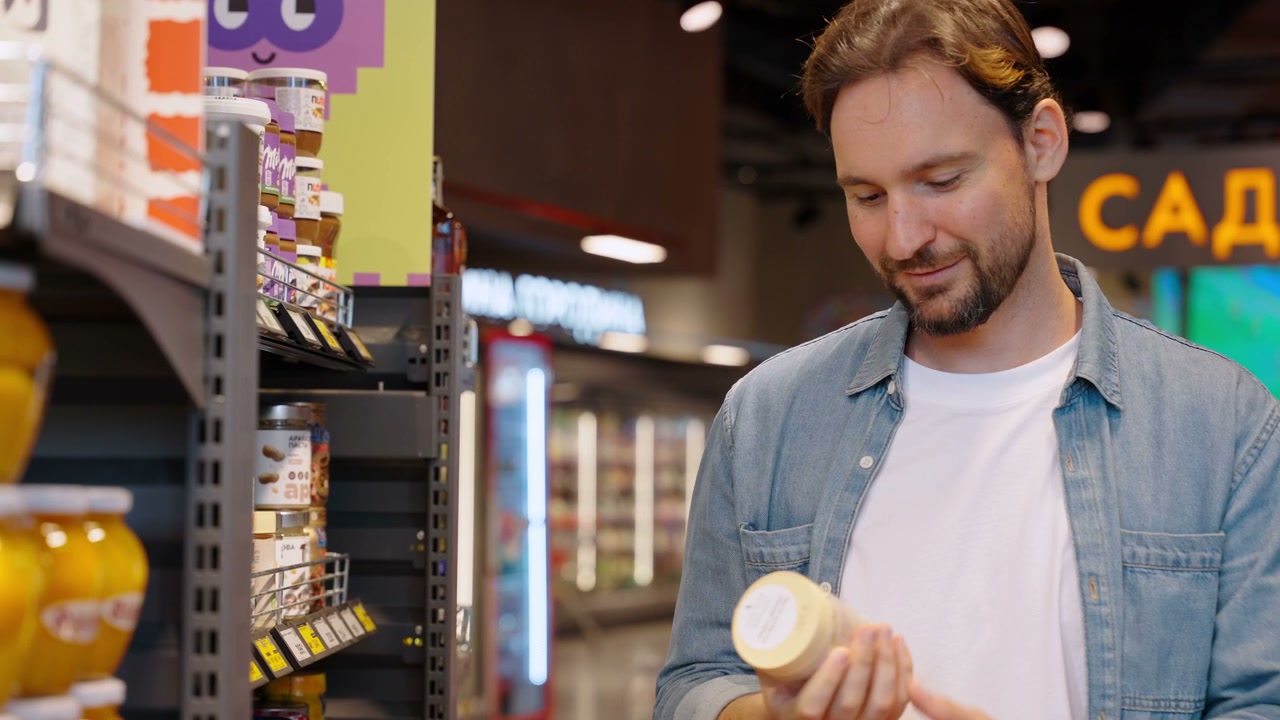 Man Shopping for Groceries in Supermarket Aisle