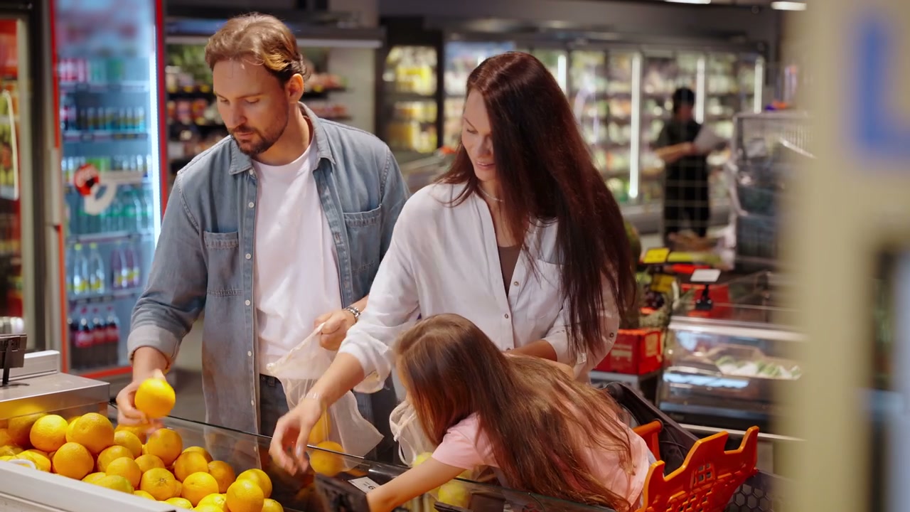 Family Buying Oranges in Supermarket