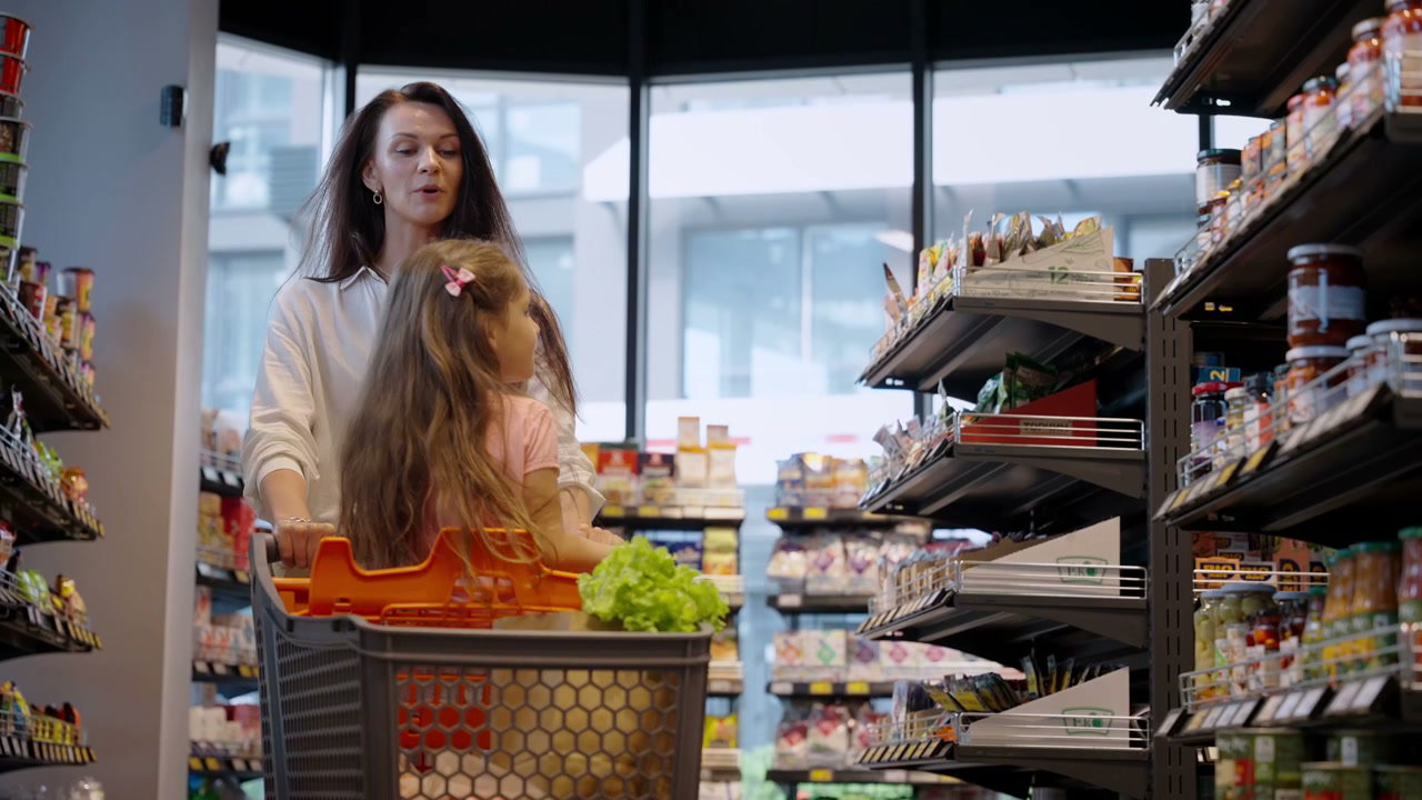 Mother and Daughter Shopping in Supermarket