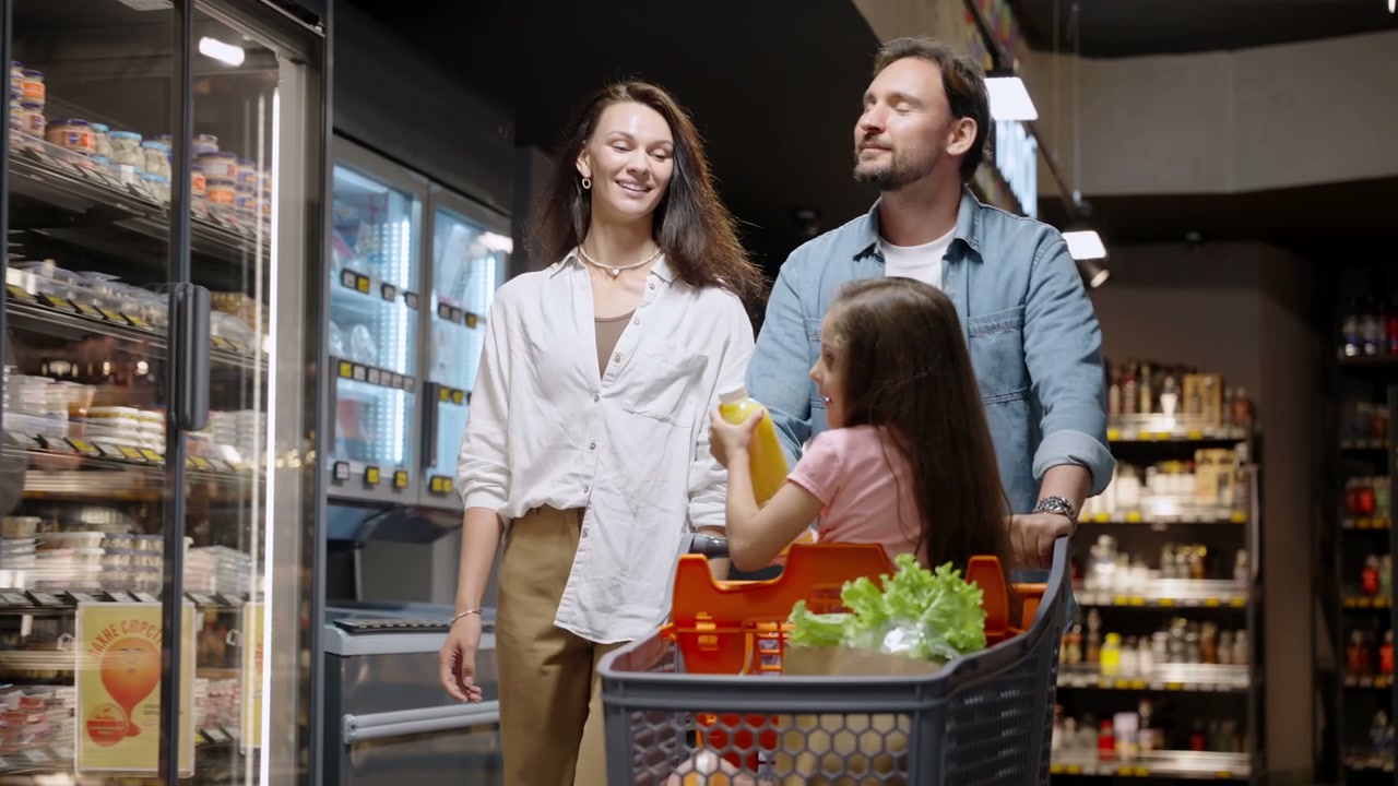 Happy Family Shopping in Grocery Store Aisle