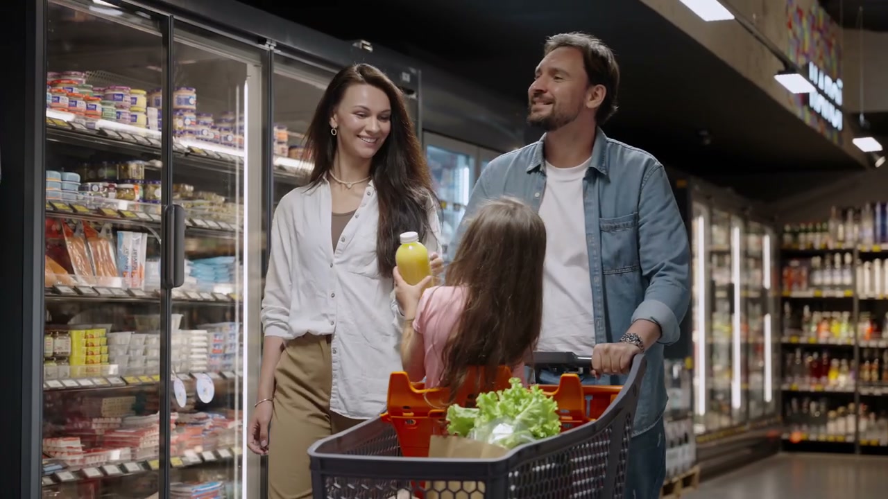 Happy Family Shopping in Supermarket