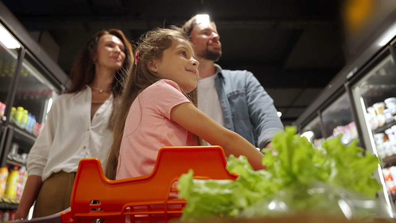 Happy Family Shopping in Grocery Store