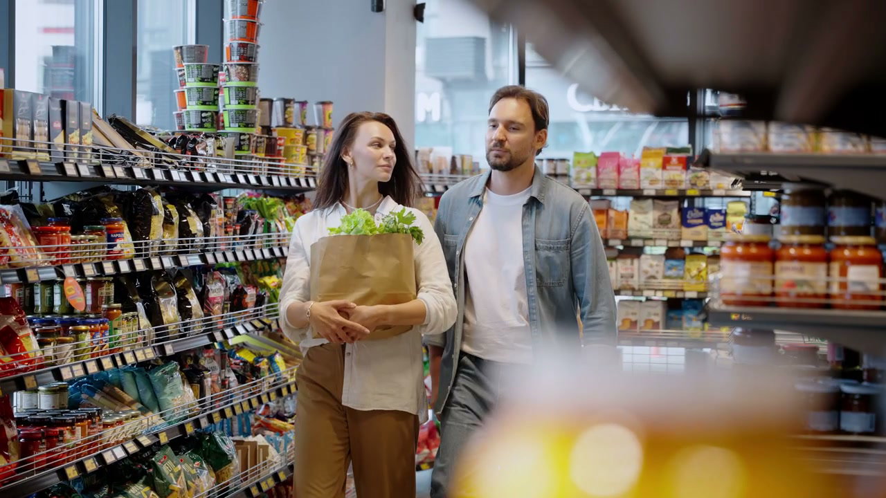 Couple Browsing Groceries in Supermarket Aisle
