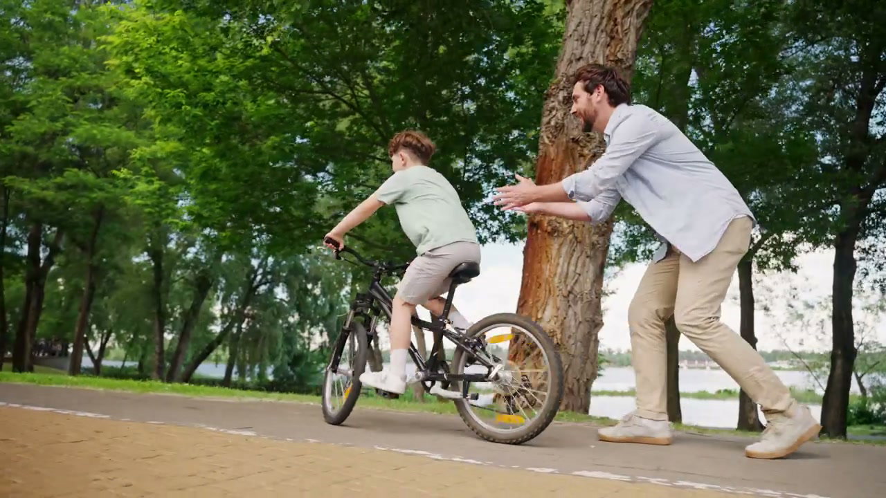 Father Teaches Son to Ride Bicycle