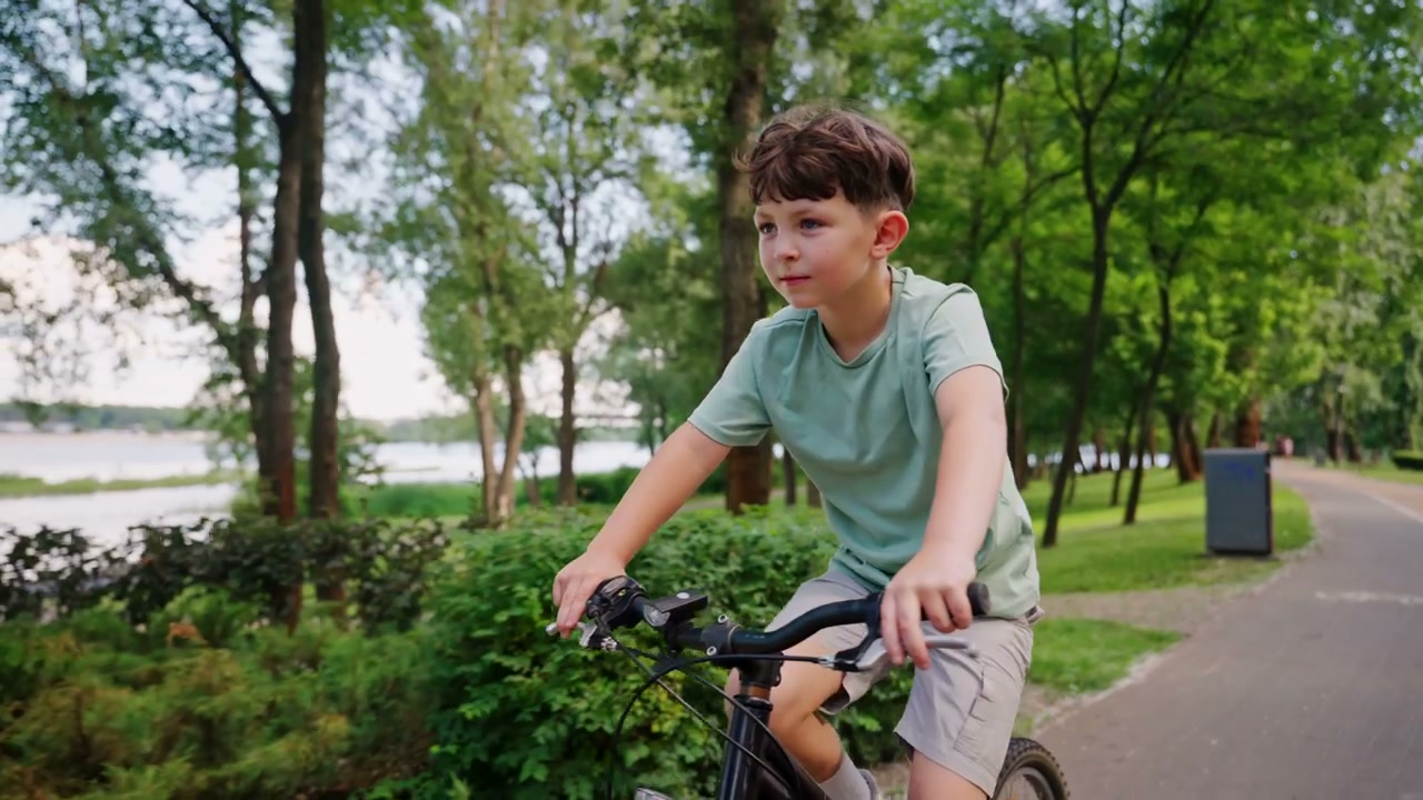 Young Boy Cycling in a Green Park