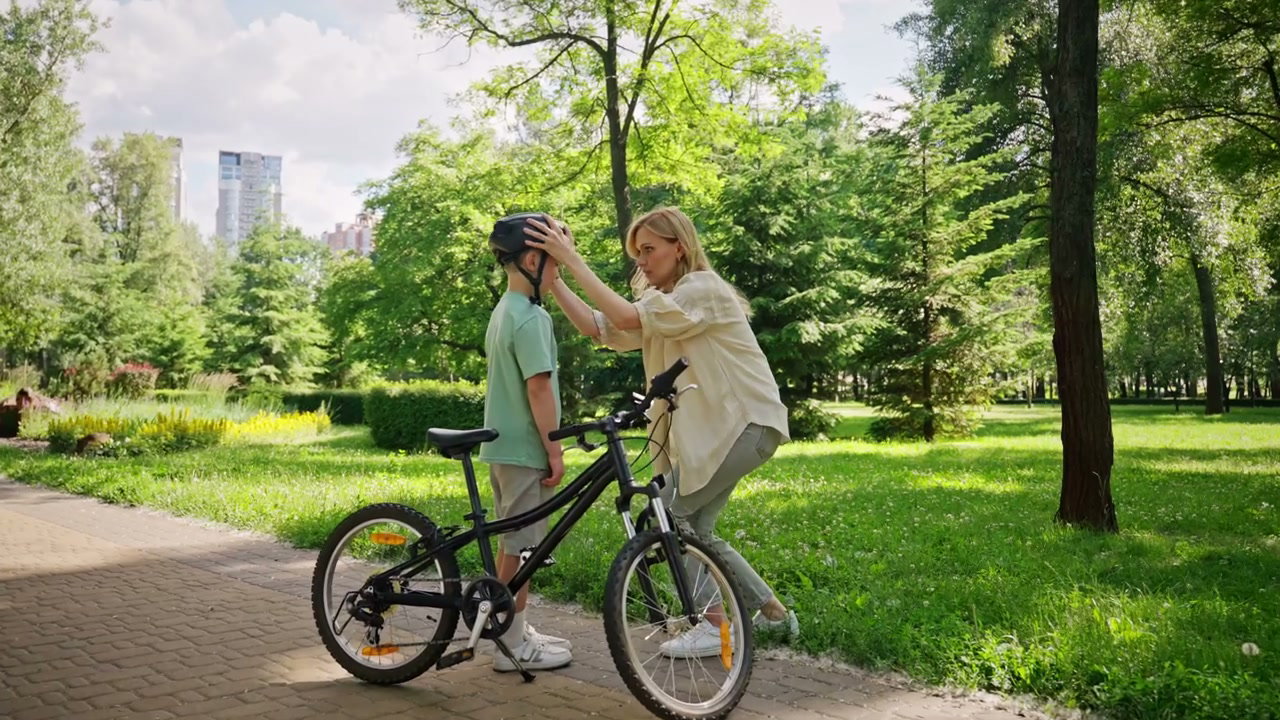 Mother Helping Son With Bike Helmet