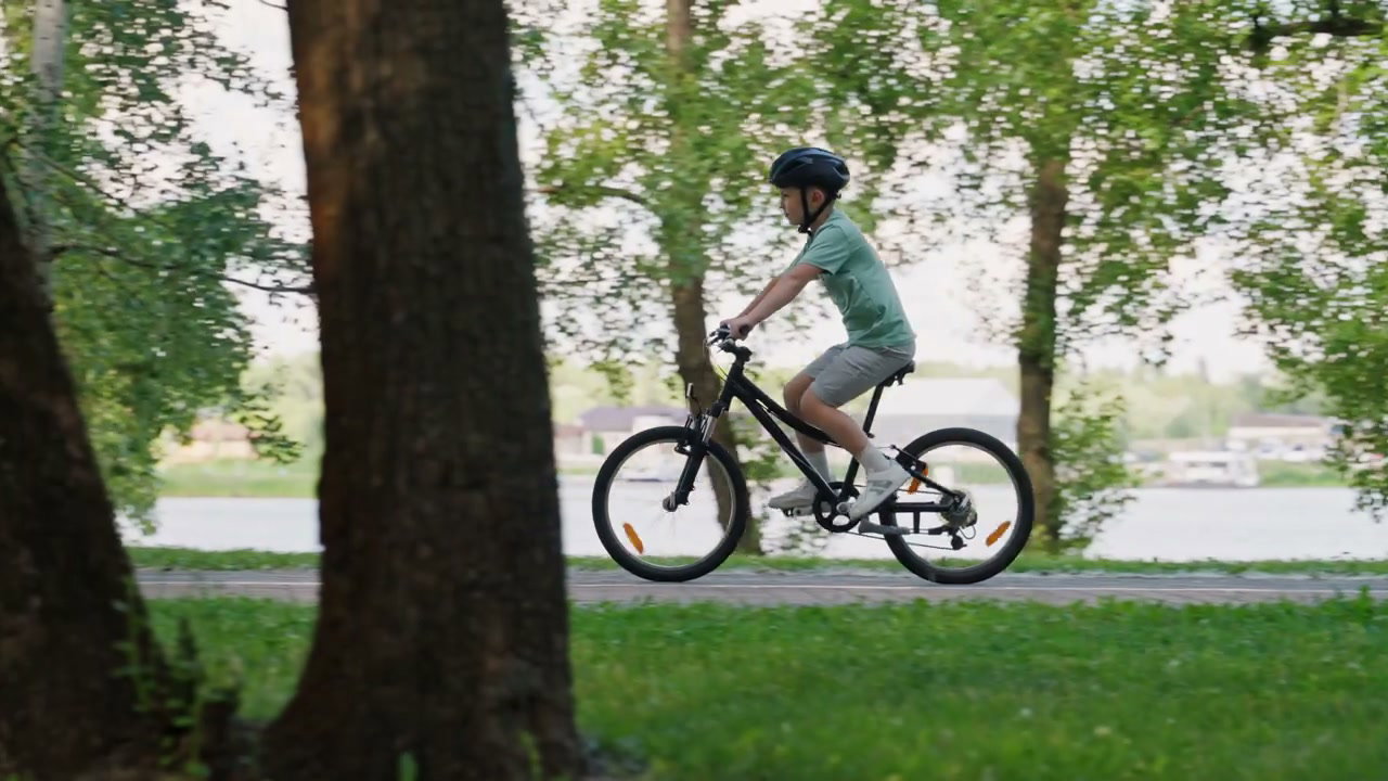 Young Boy Cycling in Green Park