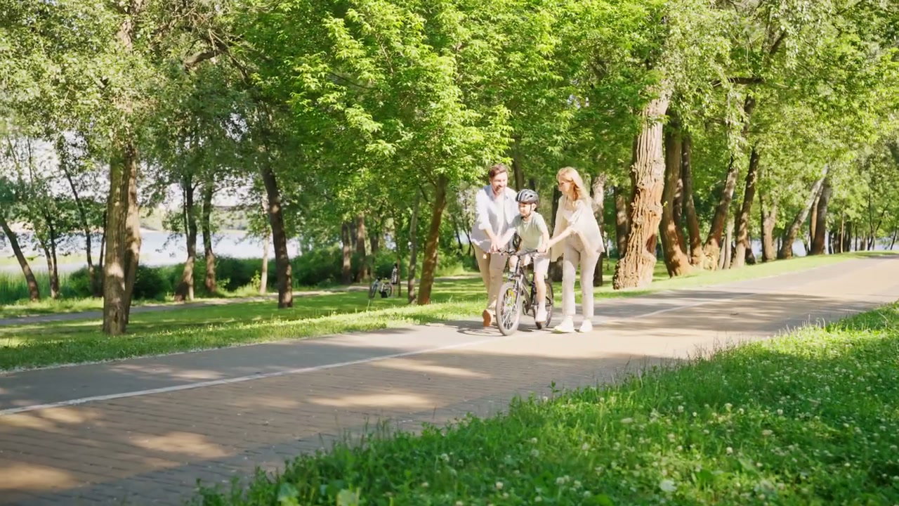 Parents Teaching Son to Ride Bike