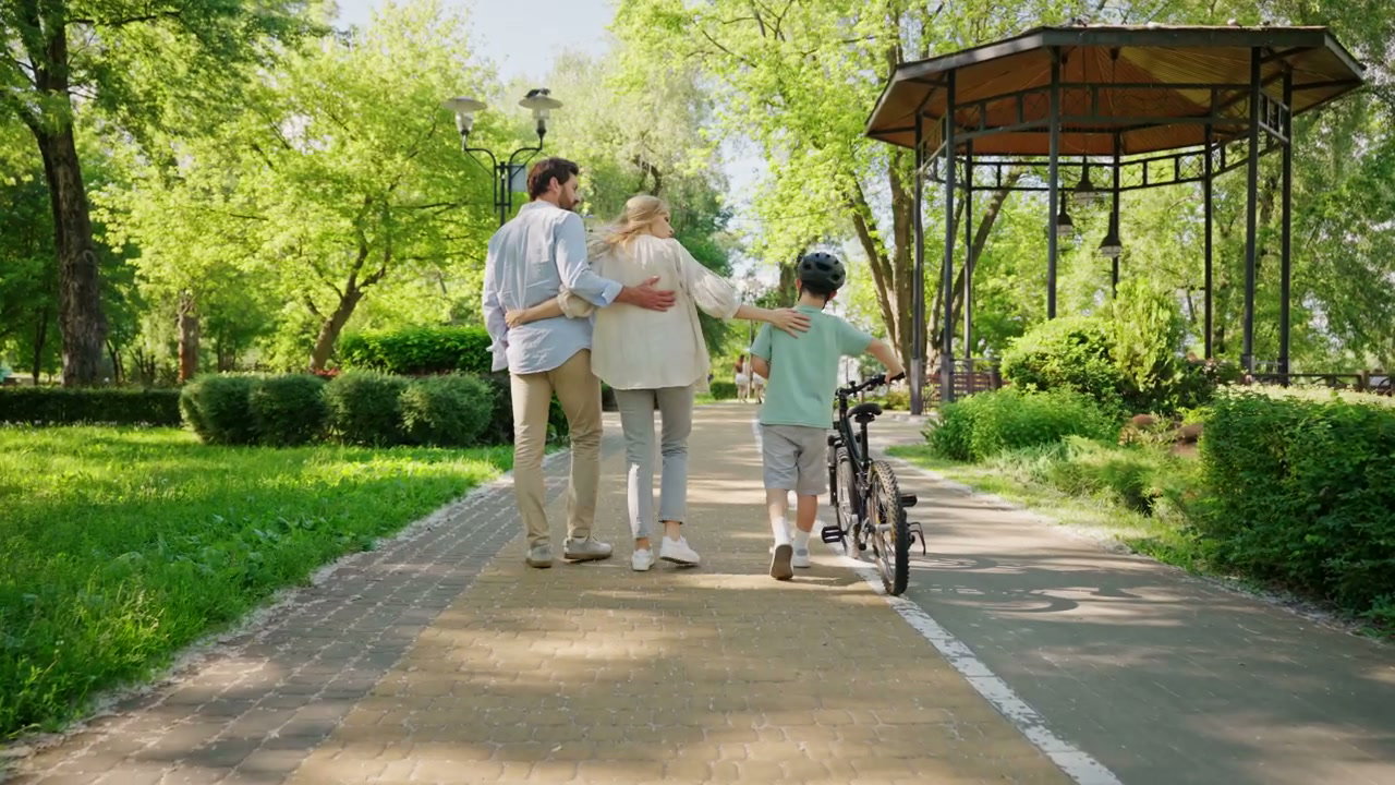 Family Walking in Park with Bicycle