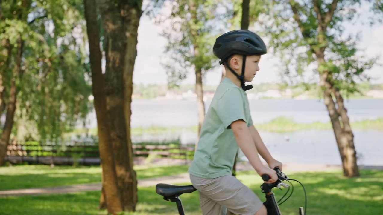 Young Boy Cycling Through a Green Park