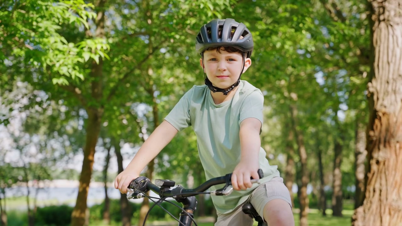 Boy Wearing Helmet on Bicycle in Park