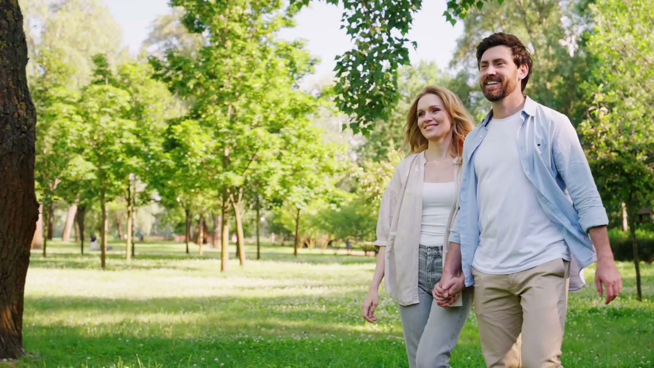 Smiling Couple Walking in Green Park