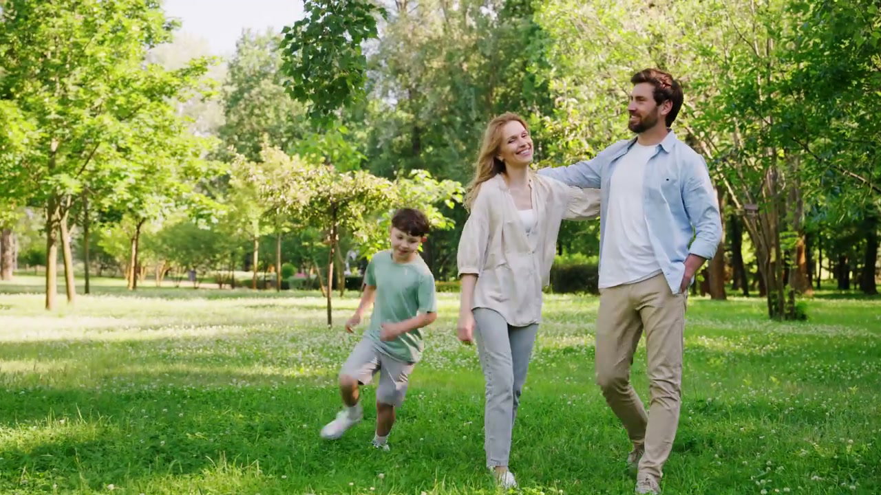 Happy Family Walking in Green Park