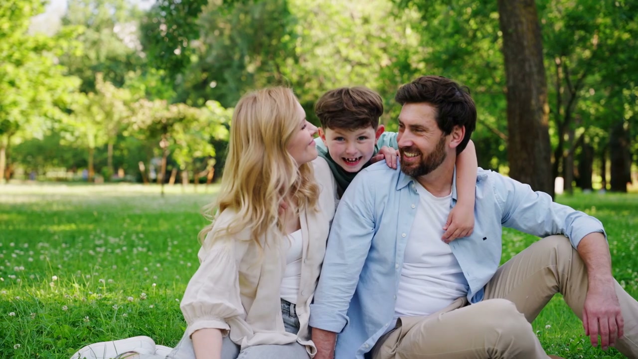 Happy Family Hugging in Park