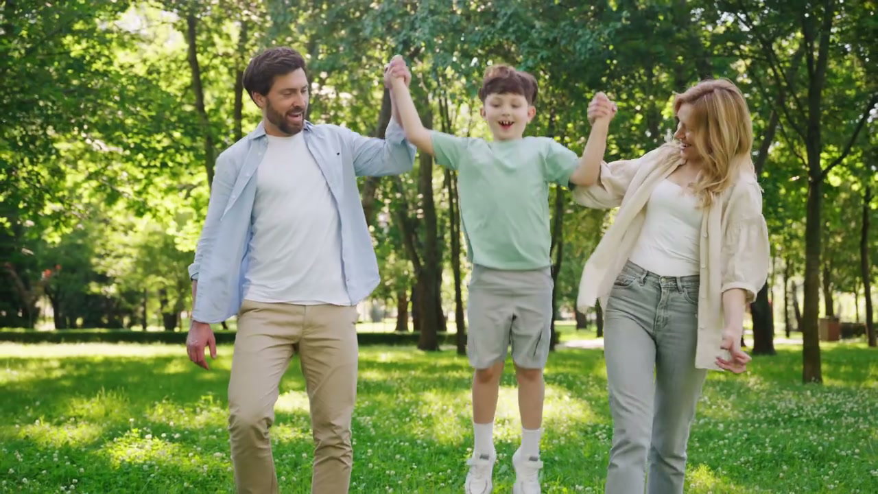 Happy Family Walking and Playing in Park
