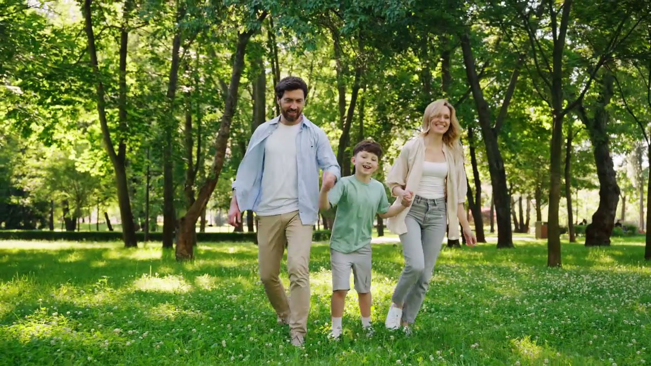 Happy Family Walking and Playing in Park