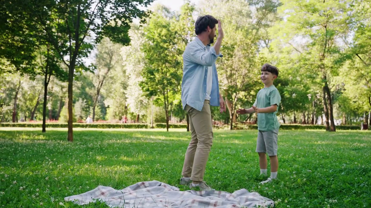 Father and Son Playing in a Sunny Park