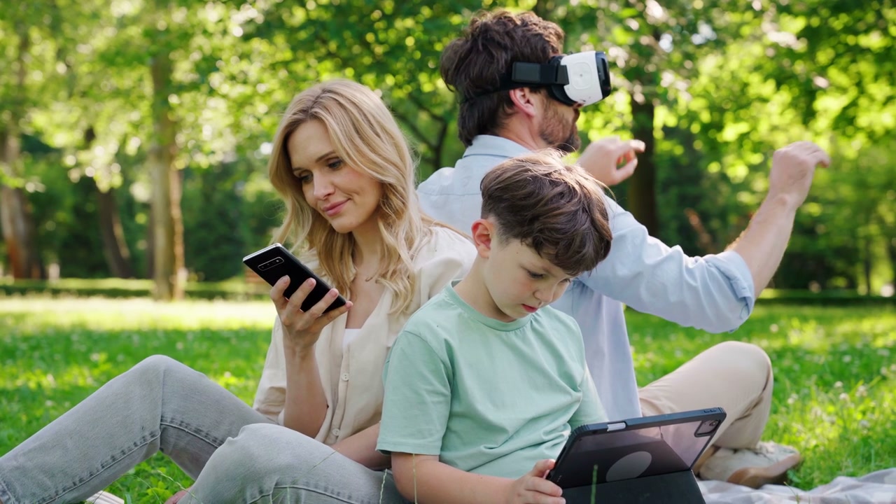 Family Using Technology in Park