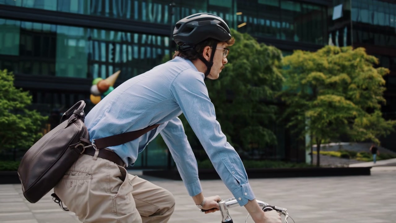 Man Cycling Through City Square