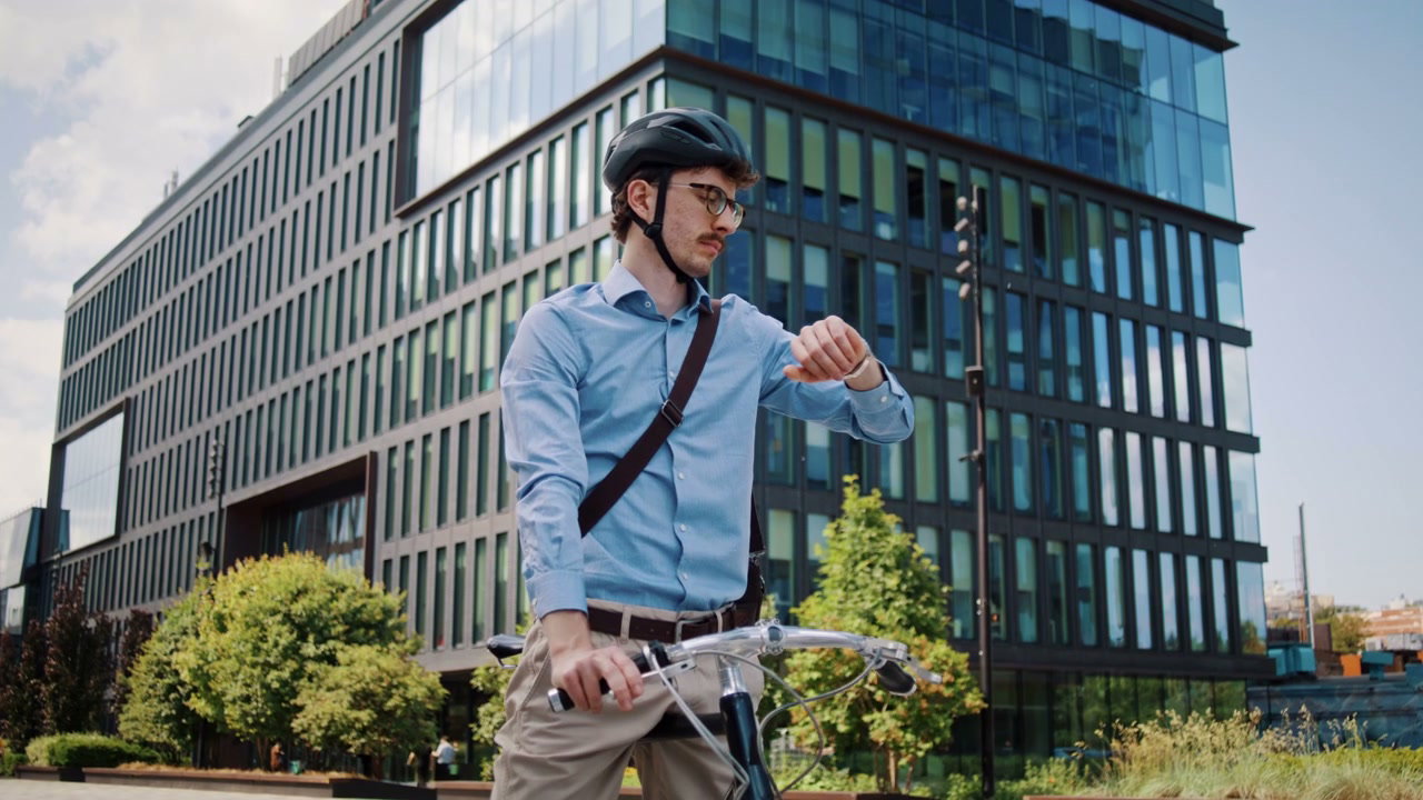 Commuter Checks Watch on Bicycle