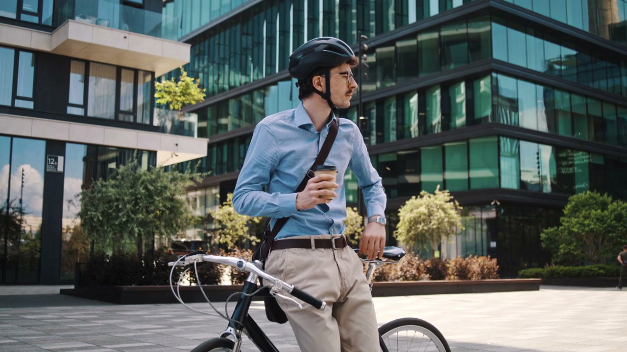 Businessman on Bike Drinking Coffee