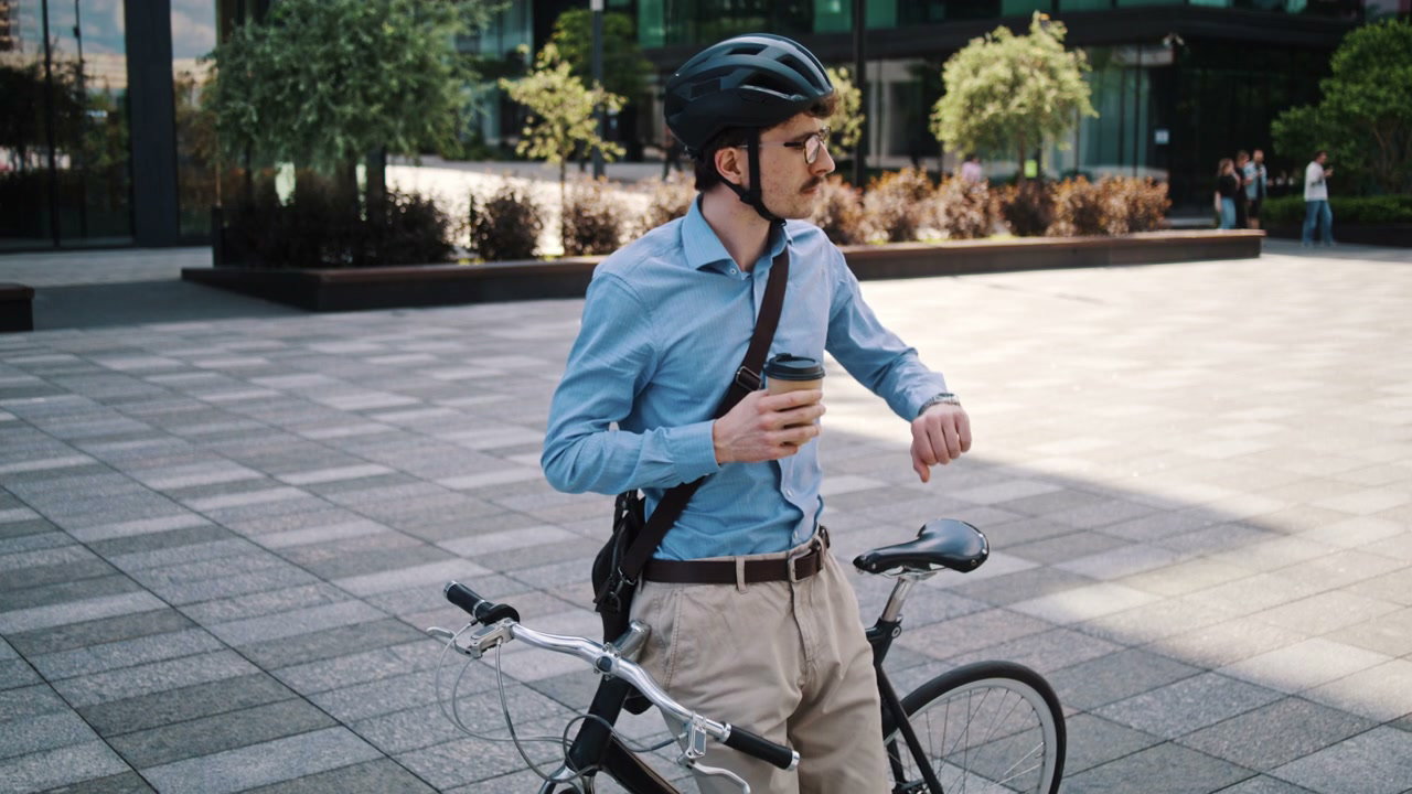 Businessman with Bike Drinks Coffee in City