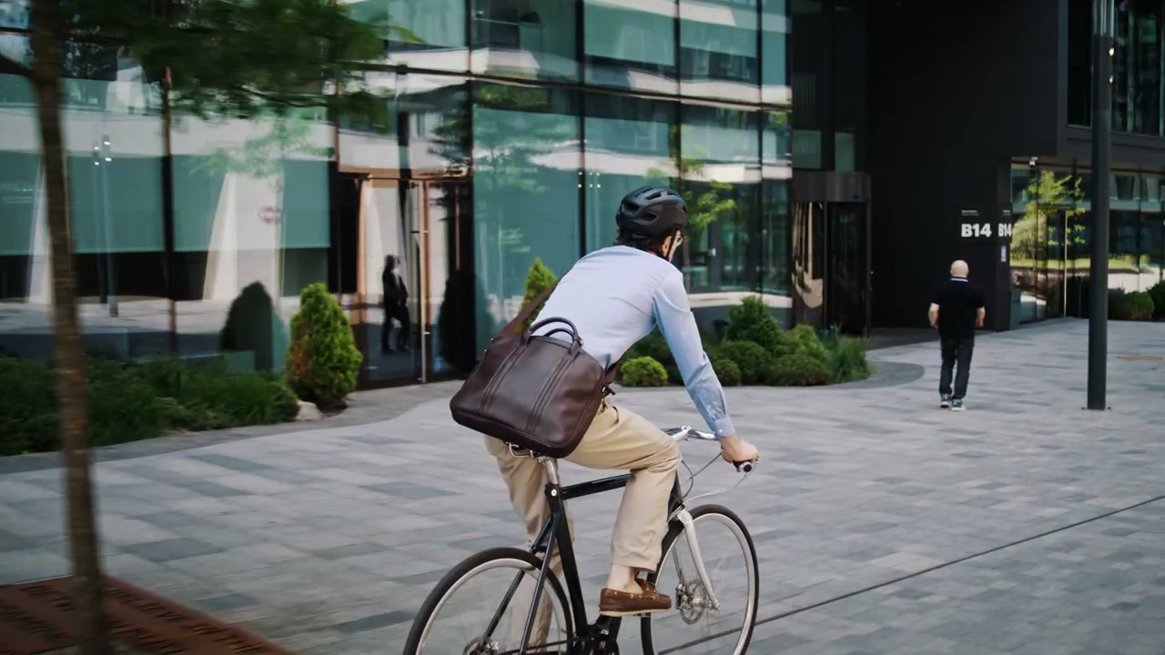 Business Person Cycling Through City
