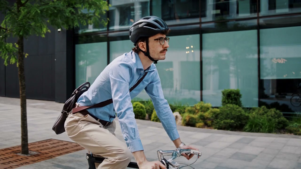 Businessman Cycling Through City Street