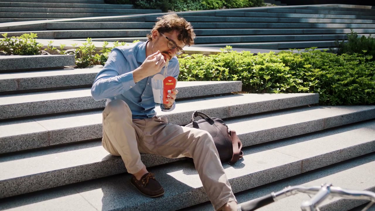 Man Eating Lunch on Stone Steps