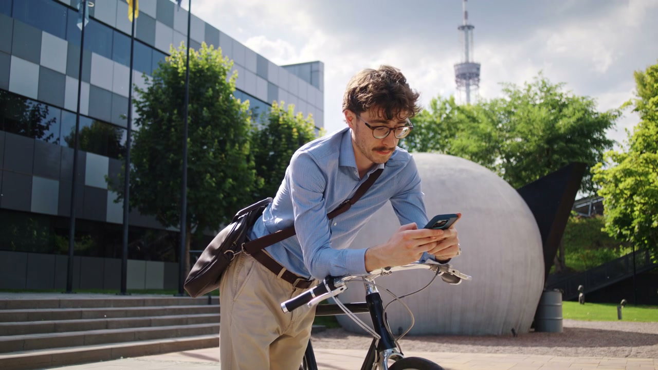 Businessman With Bicycle Using Smartphone