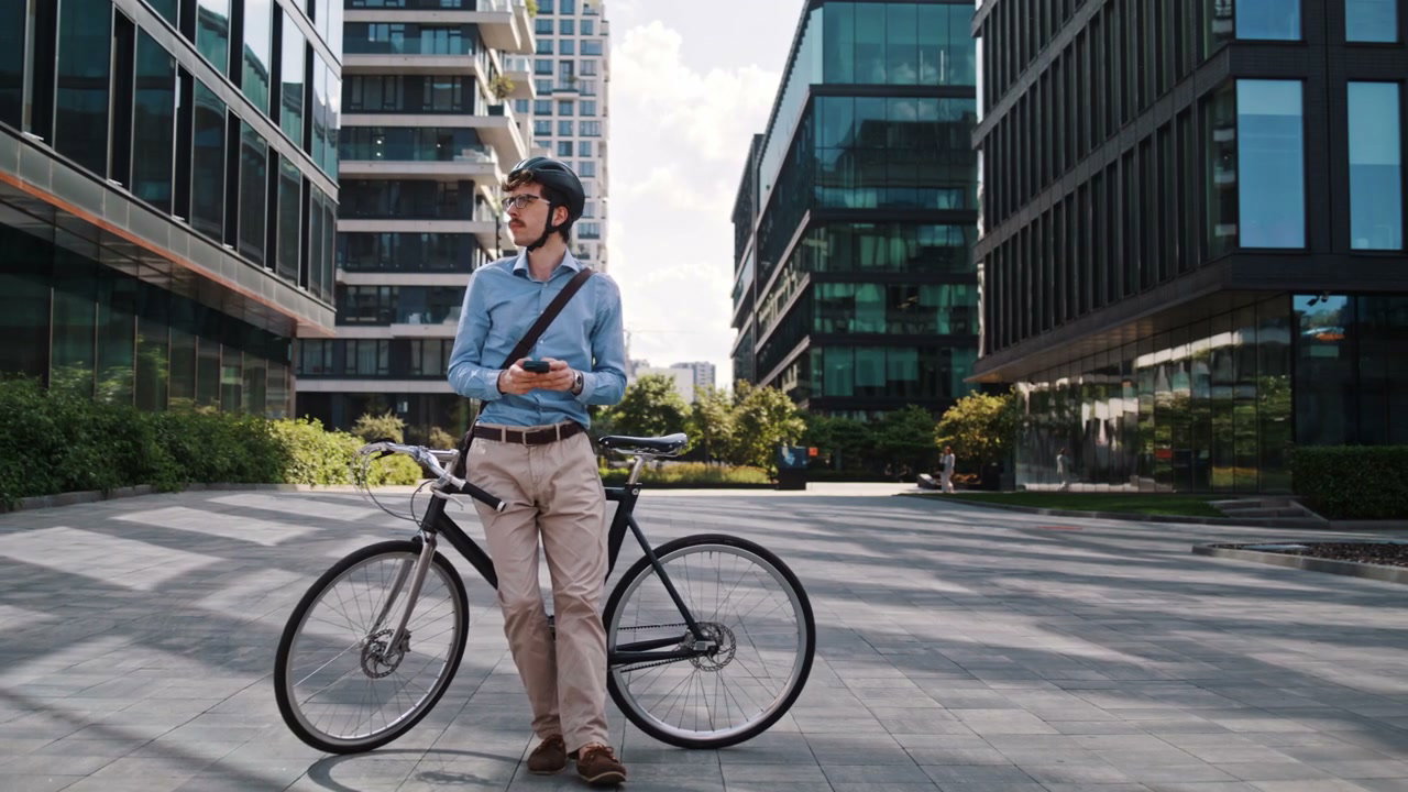Businessman with Bike Using Phone in City