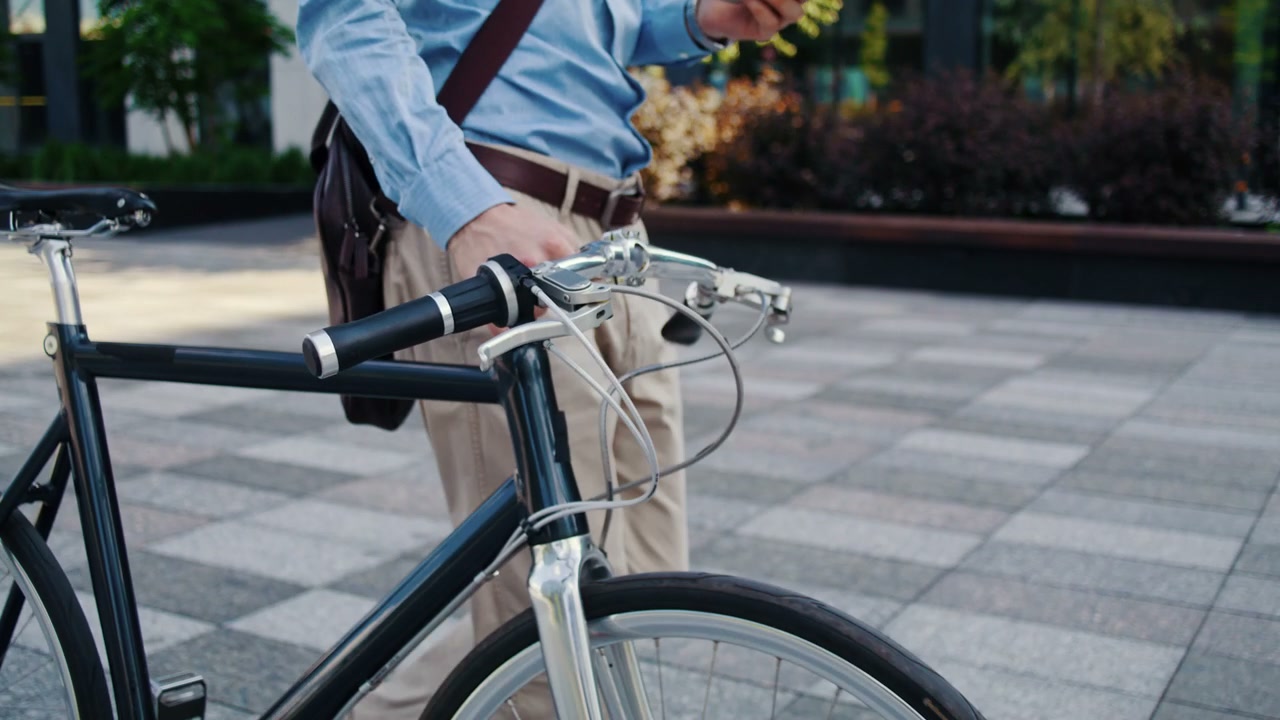 Businessman Walking Bicycle Using Phone