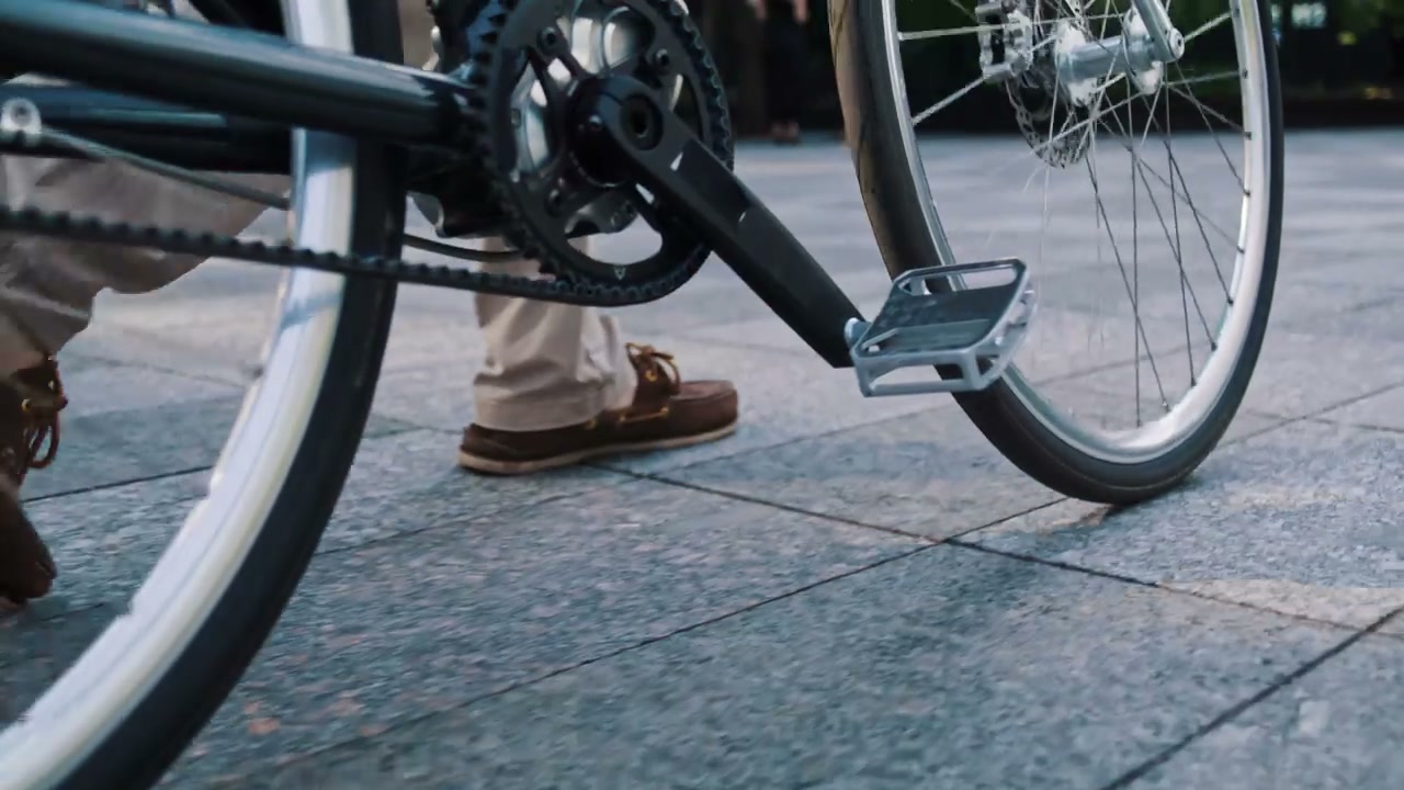 Businessman Pushing Bike and Checking Phone