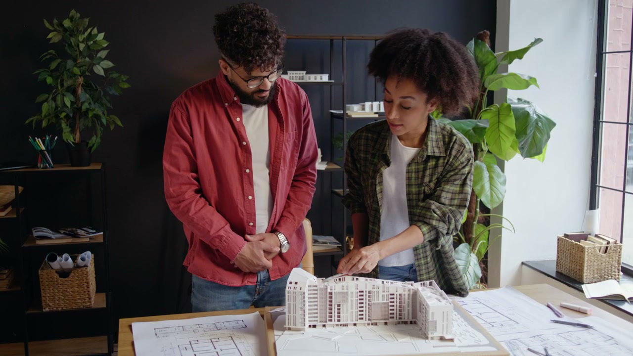 Two Architects Discussing Building Model